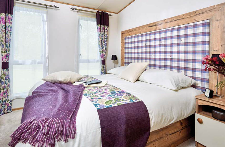 Luxurious bedroom in a holiday home for sale at Silverdyke Park