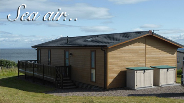 A luxury lodge over looking the sea at Silverdyke Park with text saying sea air